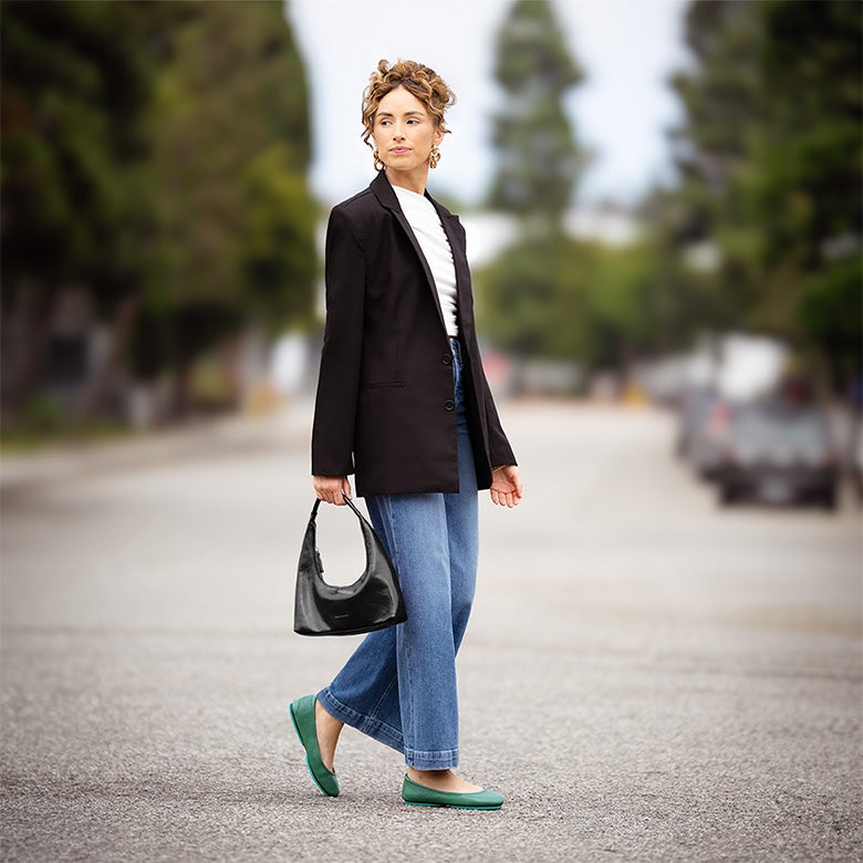 woman wearing pacific green tieks with jeans and a blazer