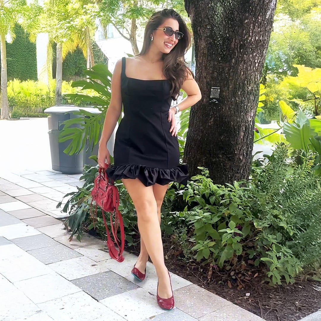 woman wearing ruby red tieks flats with a little black dress